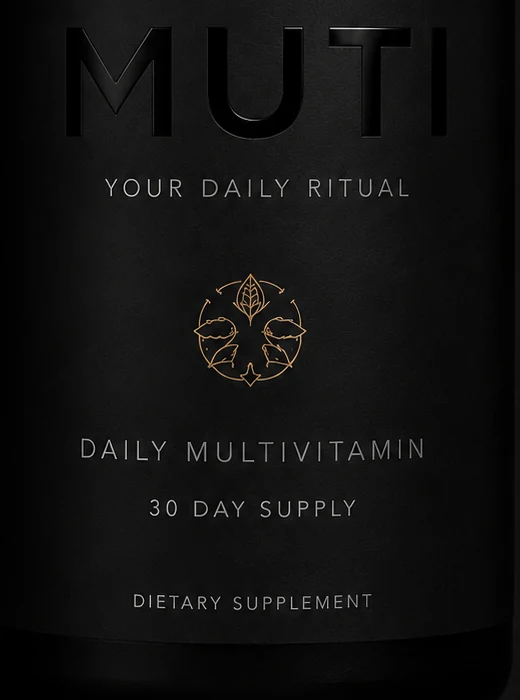 Close detail of the glossy black wordmark and bronze emblem on the MUTI bottle label
