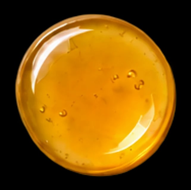 A thick drop of honey-coloured vitamin E oil