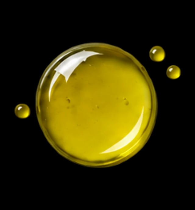 A drop of amber-green vitamin K1 oil