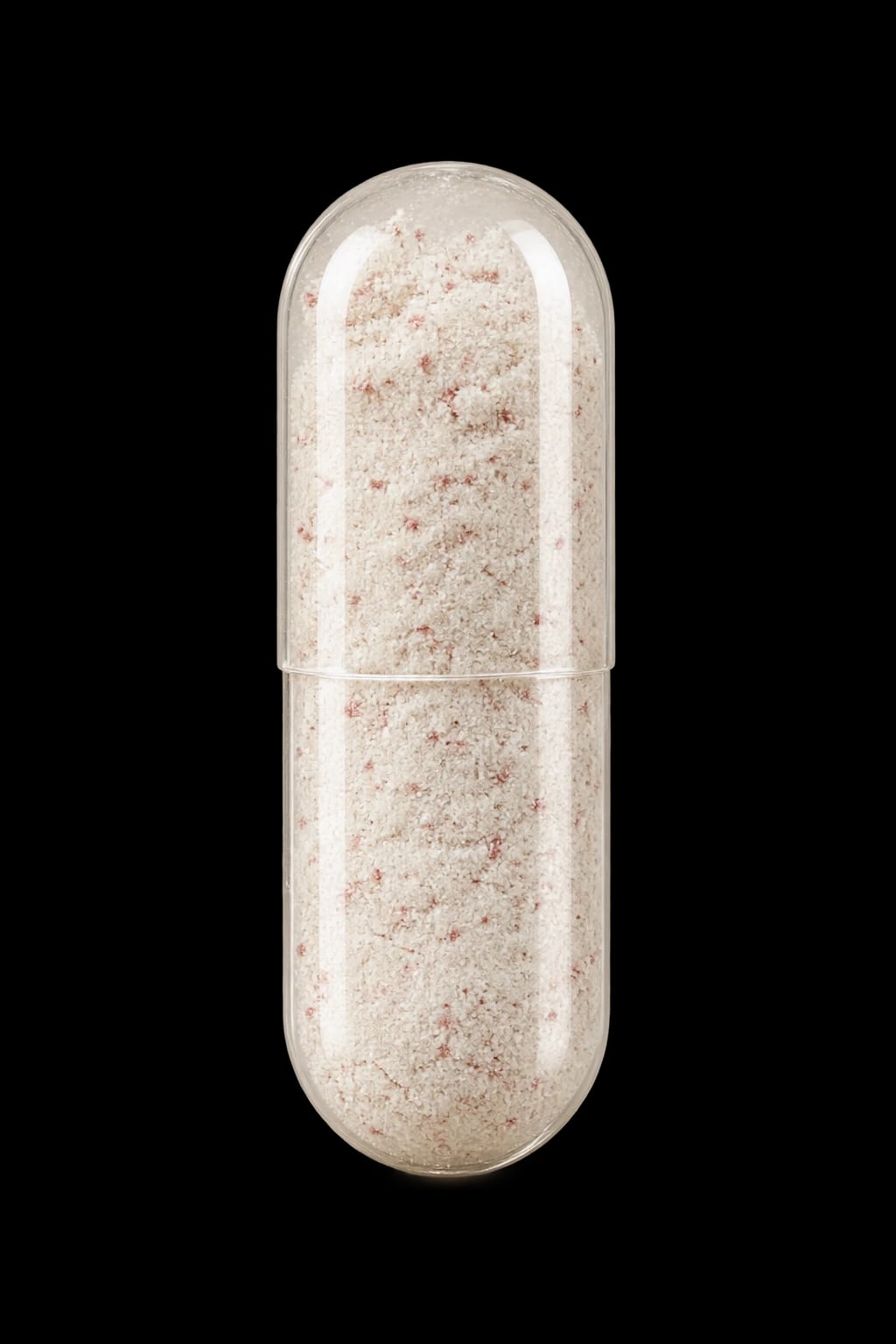A clear capsule with its pale powder visible
